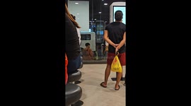 Boyfriend comforts upset partner outside fast food restaurant