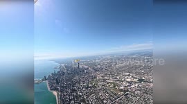 US: POV Video Shows U.S. Army Parachute Team Soar Over Chicago With American Flag