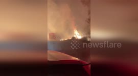 Wildfire rages alongside roads as crews battle the flames in Turkey