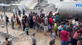 Palestinians collect limited water supplies from tankers in southern Gaza