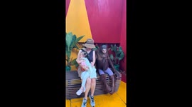 Mother and daughter pose with orangutan at Thai zoo