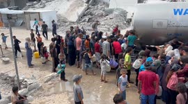 Palestinians collect limited water supplies from tankers in southern Gaza