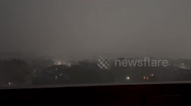 Hailstorm with thunder and lightning in foggy night in Houston, Texas