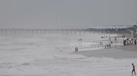 Surfers drawn to high waves as Hurricane Erin hits Wrightsville Beach in US