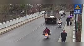 China: Pedestrian Hit By Heavy Truck’s Rear Door Slammed To The Ground