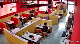 Waitress trips while carrying food but lands in kneeling position at table