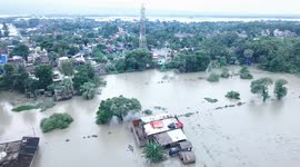 Drone footage of devastating floods in northern India as locals forced to swim through streets