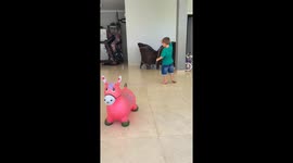 Little boy practicing lasso with toy horse in Brazil