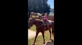 Tiny 1-year-old tot effortlessly rides horse