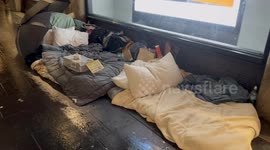 Homeless person has sign threatening to break people’s umbrellas if they drip water on his bed in Sydney, Australia