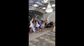 Tug-of-war over bridal bouquet at wedding reception in Ivano-Frankivsk, Ukraine