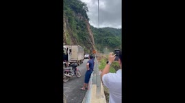 Drivers scatter as landslide crashes onto road in Vietnam