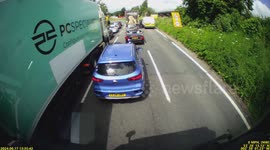 Car overtaking truck cuts up causing a collision.