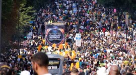 Revellers dance down Ladbroke Grove as floats provide the sounds during Notting Hill Carnival's Children's Day