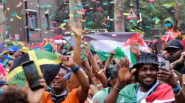 Revellers soak up the atmosphere at Notting Hill Carnival as party-goers are covered in coloured powder, paint and confetti