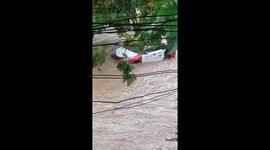 Taxi swept away by floods as river bursts its banks in the Philippines