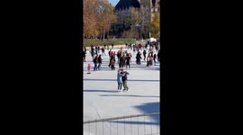 Old couple ice skating with the majestic Vajdahunyad Castle in the background