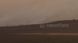 Two brave locals try to tackle the fire near Fylingdales, Whitby.