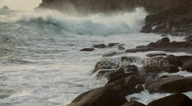 Giant waves from Hurricane Erin smash into the UK cliffs at Land's End