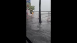 Cars navigate flooded roads as Typhoon Kajiki hits Vietnam