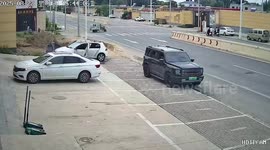 Truck swerves to avoid cargo tricycle rider and crashes through wall