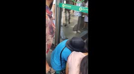 Boy with head stuck between glass door and hinge is rescued in China