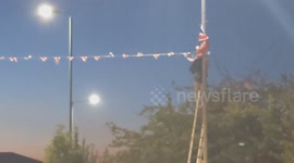 Harlow, United Kingdom – 08/25/2025 – A group of residents gathered along Southern Way in Harlow, Essex, at 8:00 PM to participate in