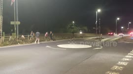 Harlow, United Kingdom – 08/25/2025 – A group of residents gathered along Southern Way in Harlow, Essex, at 8:00 PM to participate in