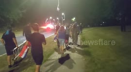 Harlow, United Kingdom – 08/25/2025 – A group of residents gathered along Southern Way in Harlow, Essex, at 8:00 PM to participate in