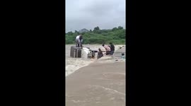 Locals rescue couple form jeep swept away by fast-flowing river