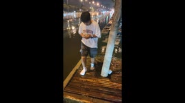Man slips and falls on flooded wooden sidewalk in Neimenggu, China
