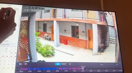 Woman slips and falls while pulling suitcase in Henan, China