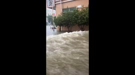 Bus drives through flooded road in Guangdong, China
