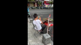 Boy plays mobile games on cracked screen in Hainan, China