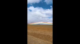 Rare low rainbow over barren landscape in Shanxi, China