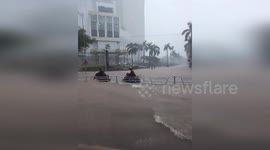 Vietnam: People Driving Motorcycles Through Deep Water On Flooded Streets In Hanoi
