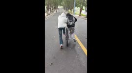 Two Students Riding One Bicycle
