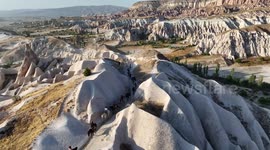 Türkiye: Tourists ride through Türkiye's Cappadocia as iconic balloons rise at sunrise