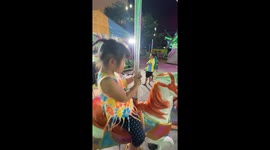 Schoolgirl rocks out on fairground carousel