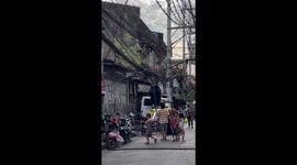 Manila slum residents hang their clothes out to dry on city's phone lines