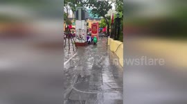 Against the Current: Hanoi Motorcyclists Defy Typhoon Kajiki's Flood