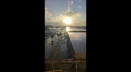 Waves crash onto cargo ship deck east of Australia