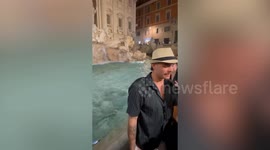 Rogue tourist escorted away by police after jumping in Trevi Fountain CLOTHED