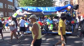 Notting Hill Carnival 2025 - Jolly Buccaneers steel pan musicians with a dancing photographer and crowds