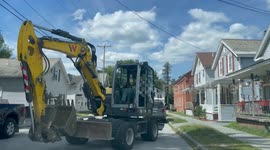 Backhoe in town digging holes for city of Bennington Vermont