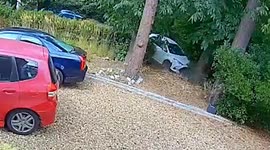Dramatic moment car flies off road and crashes through garden wall