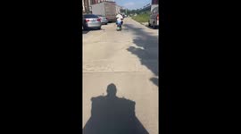 Motorcycle rider spills helmets and son's slippers while riding over bumpy road