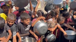 Displaced Palestinians in Gaza queue for food under blockade