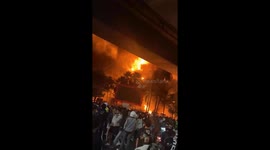 Protesters cheer as government building is set alight killing three council staff in Indonesia