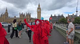 Red rebels unfold banner on westminster bridge saying stop polluting our rivers